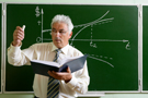 Business professor lecturing in front of chalkboard